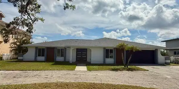Image 3: Single story home featuring a garage, fence, driveway, stucco siding, and a front yard