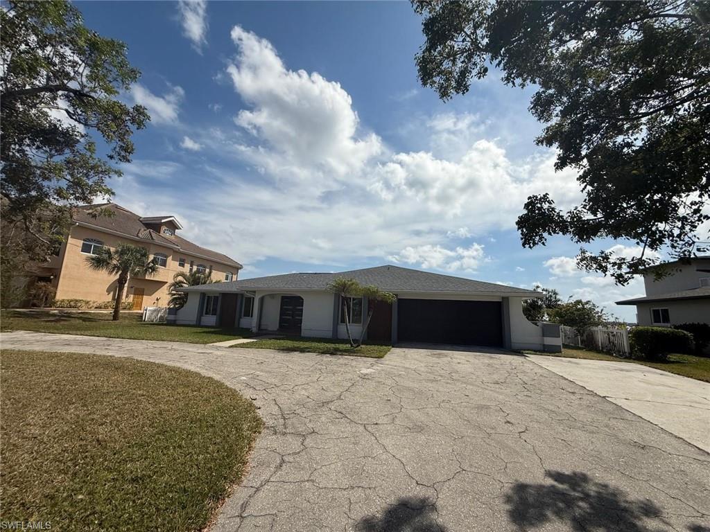 Image 4: View of front of house featuring a garage, a front yard, and concrete driveway