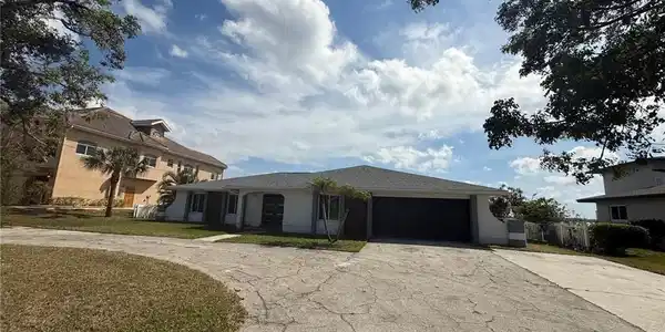 Image 4: View of front of house featuring a garage, a front yard, and concrete driveway