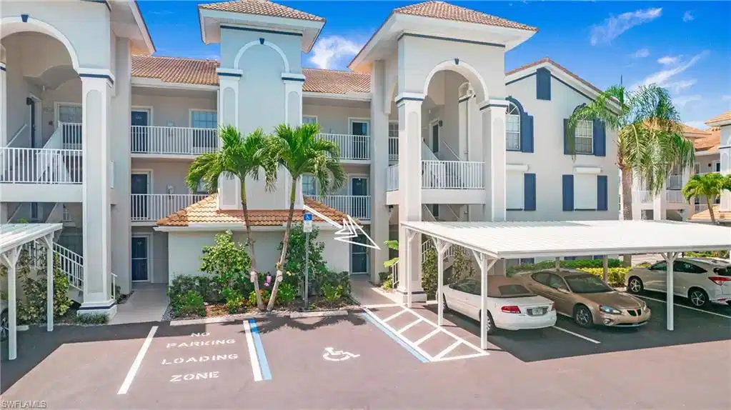 Image 1: View of building exterior featuring covered and uncovered parking
