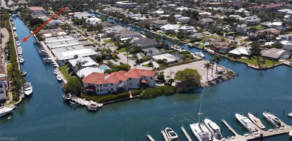 Image 2: Aerial view of a Curlew Canal leading out to Naples Bay