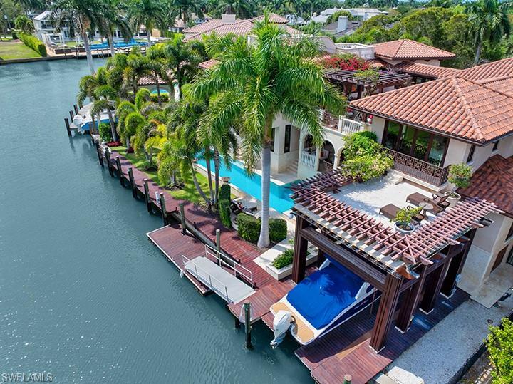 Image 2: Bird's eye view of a nearby body of water and a pool area