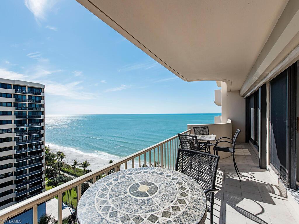 Image 2: Balcony featuring a water view and outdoor dining space