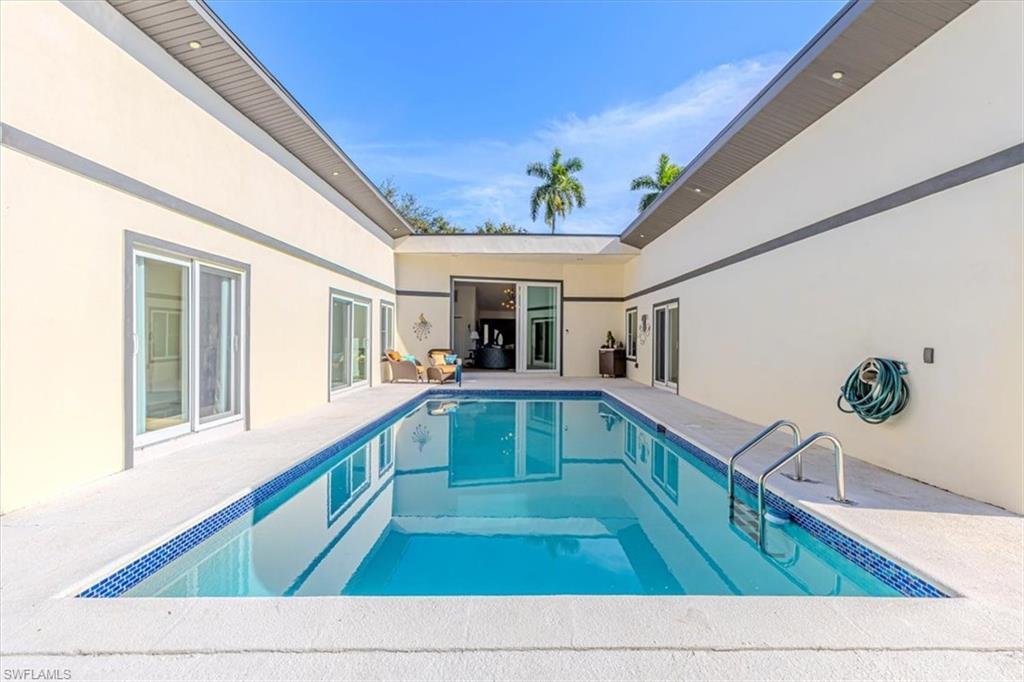 Image 1: Swimming pool featuring a patio area