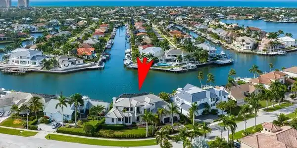 Image 2: Aerial perspective of suburban area with a nearby body of water