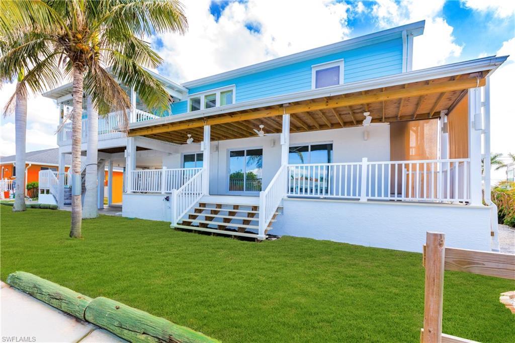 Image 4: Rear view of house with a yard, a porch, and ceiling fan
