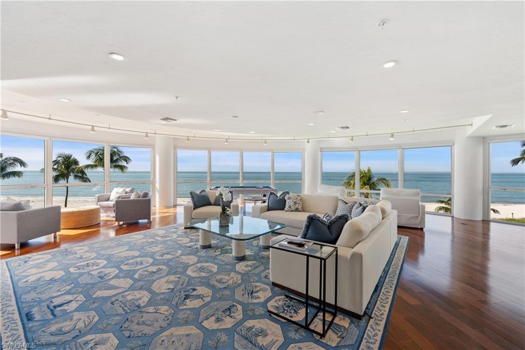 Image 3: Living area featuring a water view, dark wood-style floors, healthy amount of natural light, and recessed lighting