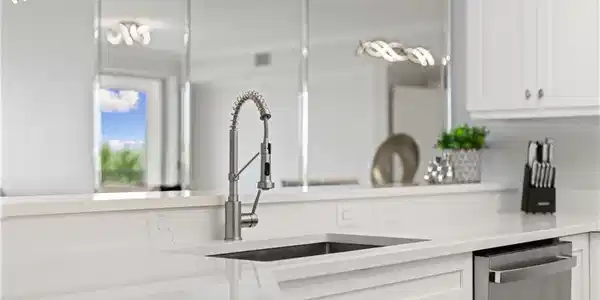 Image 2: Kitchen featuring dishwasher, white cabinets, and light stone countertops