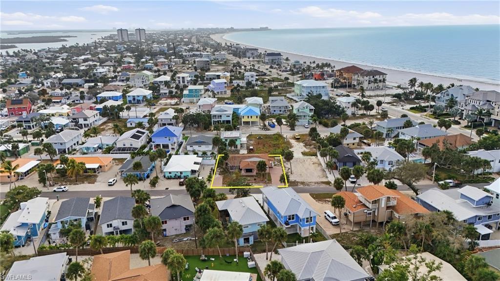 Image 2: Aerial perspective of suburban area featuring a large body of water - Virtually Edited Image