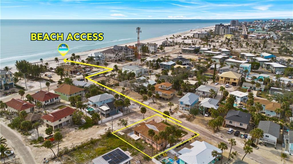 Image 4: Aerial view of residential area featuring extended coastline and property boundaries highlighted - Virtually Edited Image