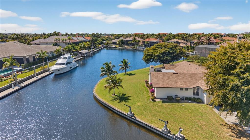 Image 3: Aerial view of residential area featuring a large body of water