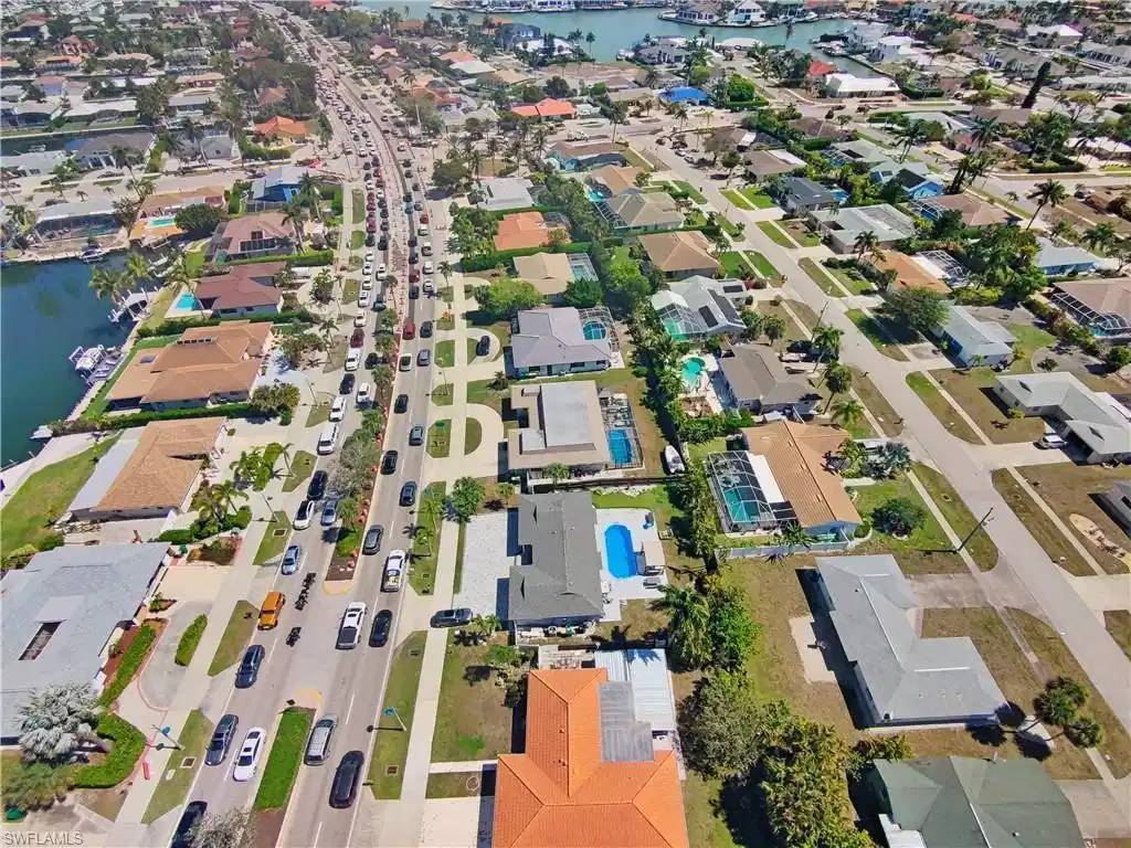 Image 1: Aerial overview of property's location with nearby suburban area and a nearby body of water