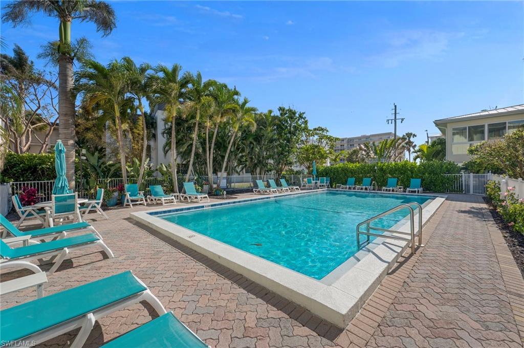 Image 2: Community pool with a patio