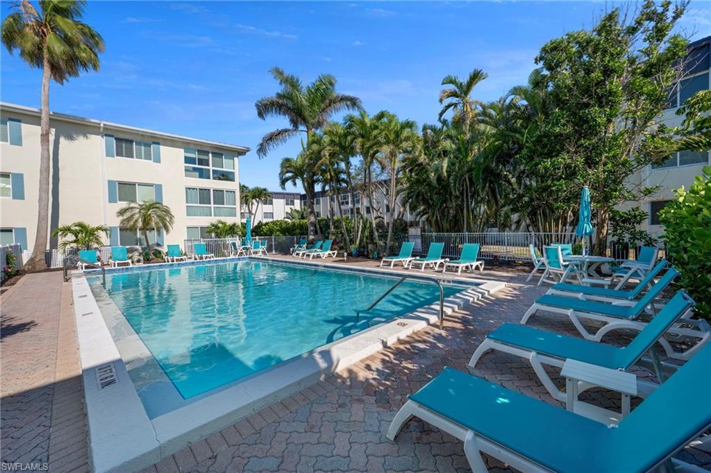 Image 3: Community pool featuring a patio