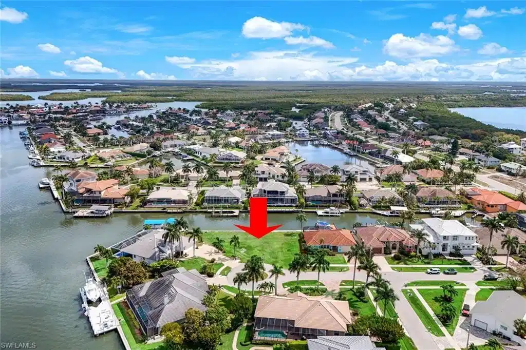 Image 1: Aerial view of residential area featuring a large body of water