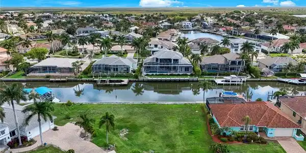 Image 2: Aerial perspective of suburban area featuring a large body of water