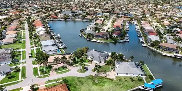 Image 3: Aerial perspective of suburban area featuring a large body of water