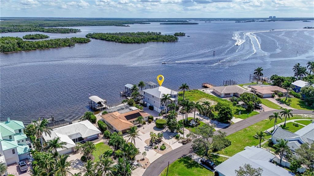 Image 2: Aerial view of residential area featuring a nearby body of water - Virtually Edited Image