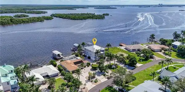 Image 2: Aerial view of residential area featuring a nearby body of water - Virtually Edited Image
