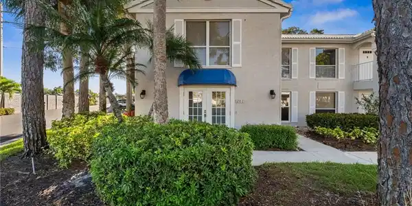 Image 3: View of front of property with stucco siding and french doors