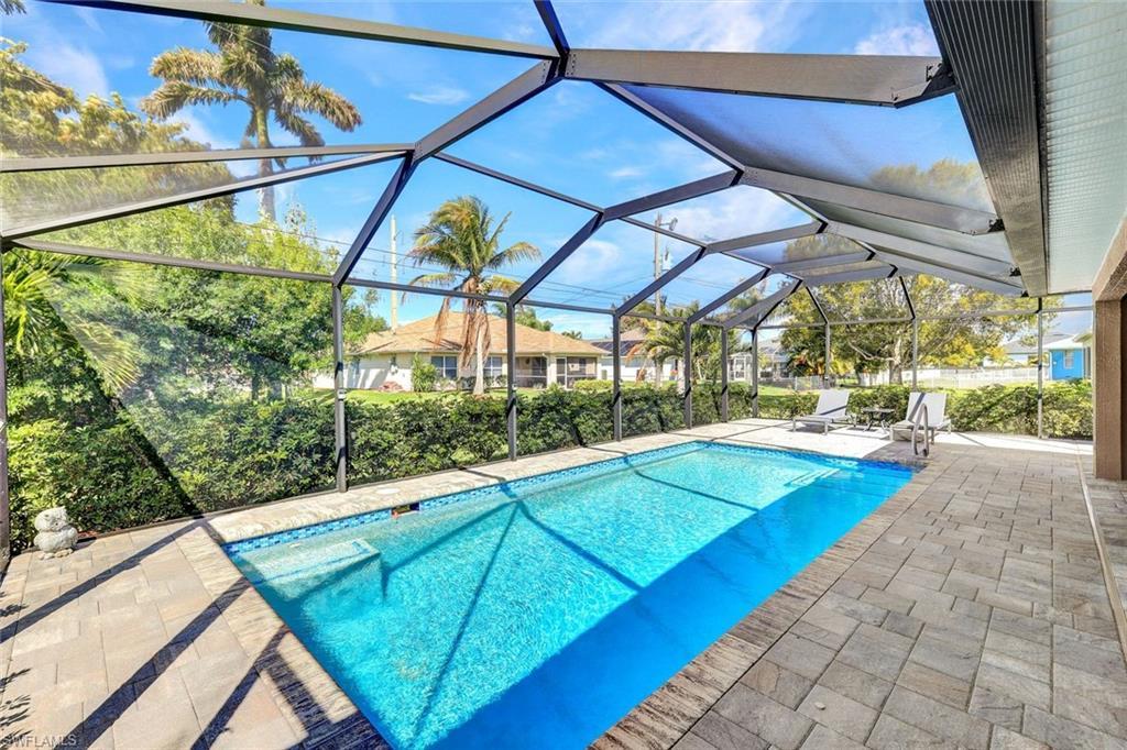 Image 2: Outdoor pool with a sunroom, a patio, and glass enclosure