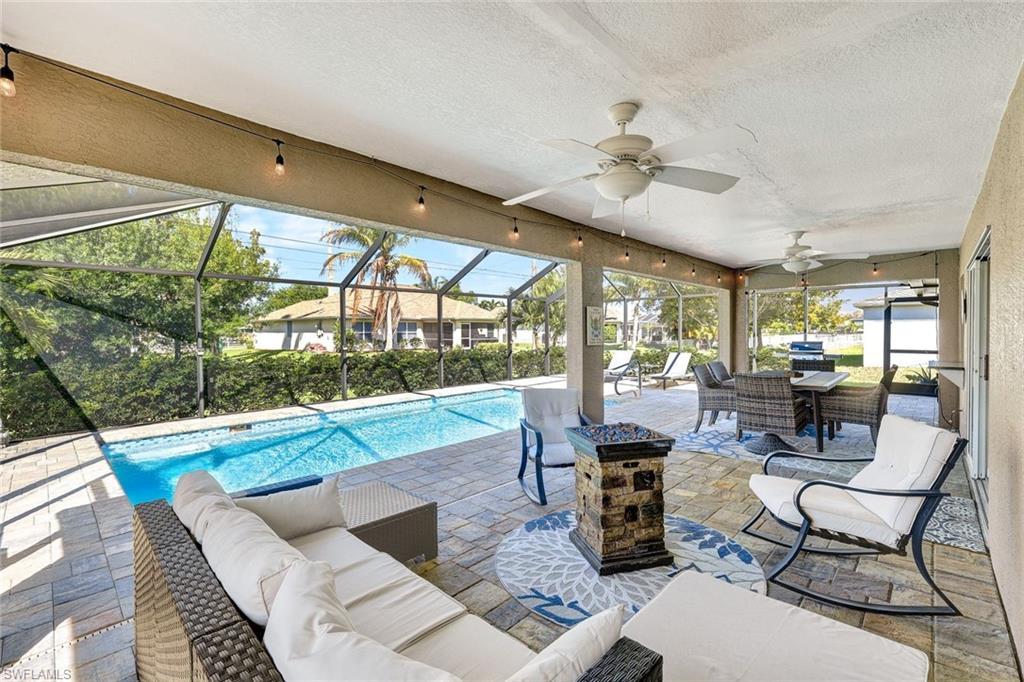 Image 3: Outdoor pool with a patio, an outdoor living / dining area, a sunroom, and glass enclosure