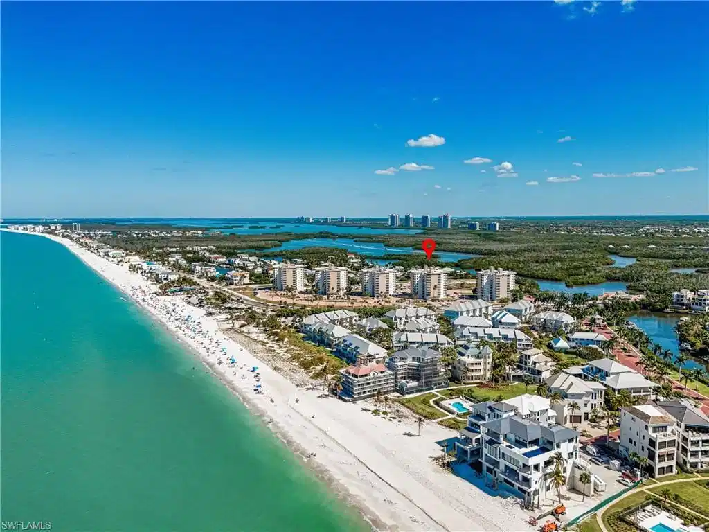 Image 1: View of urban area featuring expansive beach