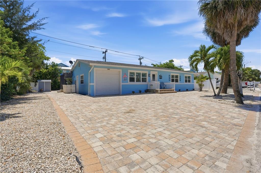 Image 3: Single-story residence featuring a light blue exterior with white trim - Virtually Edited Image