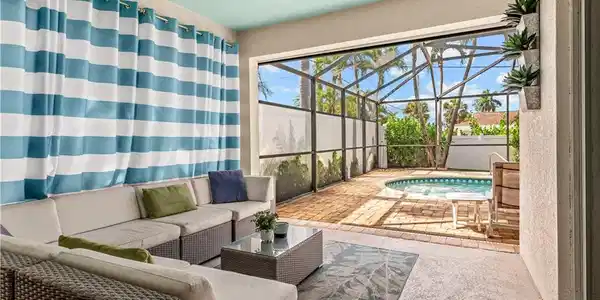 Image 3: Cover patio and sitting area in the screened in lanai