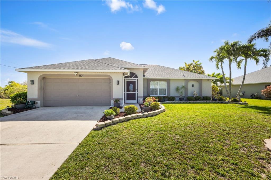 Image 2: Ranch-style house featuring stucco siding, a garage, concrete driveway, a front yard, and a shingled roof