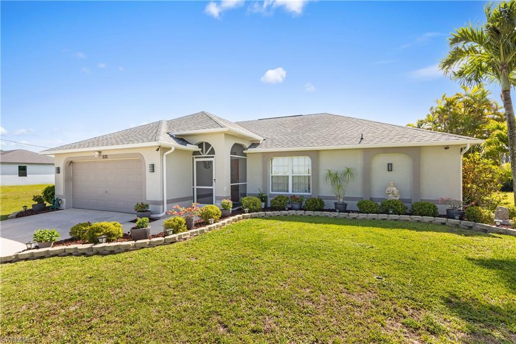 Image 3: Ranch-style house featuring driveway, stucco siding, an attached garage, and a front yard