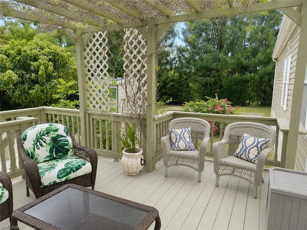 Image 3: Spacious outdoor deck featuring a wooden pergola, lattice accents, and perimeter railing