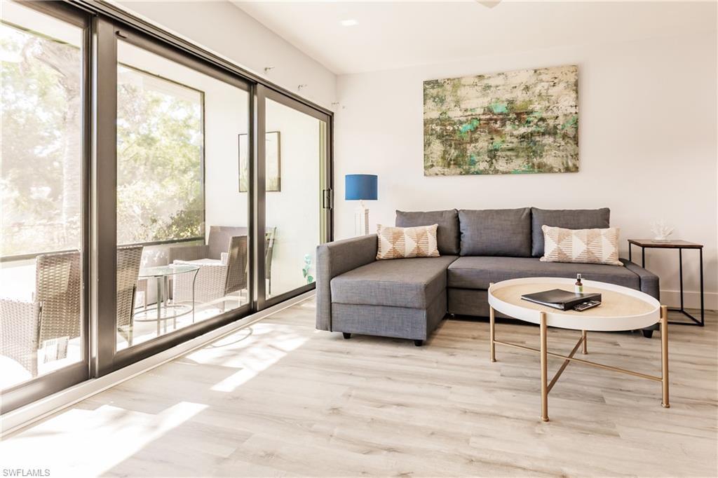 Image 4: Living area featuring baseboards and light wood finished floors