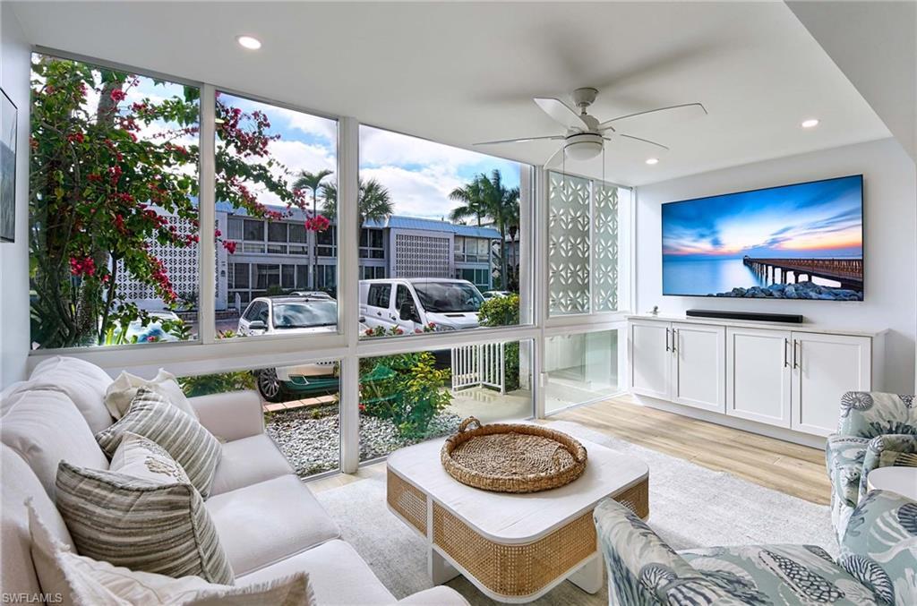 Image 3: Living room with ceiling fan, light hardwood / wood-style flooring, and floor to ceiling windows