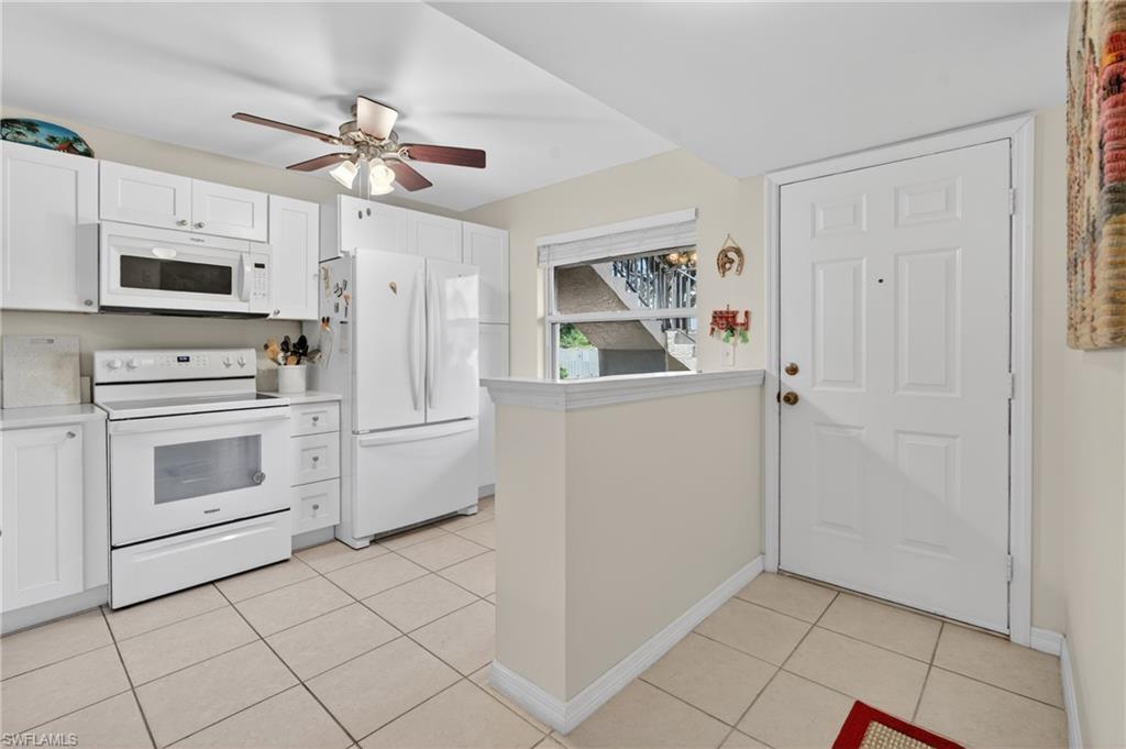 Image 4: Kitchen featuring white cabinetry, white appliances, a ceiling fan, and tile flooring
