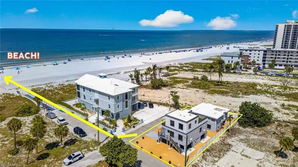 Image 1: Gulfview properties Two modern multi-story structures with flat roofs, featuring exterior staircases and elevated outdoor decking