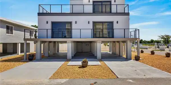 Image 4: 71 Mango - Modern new construction 2 Units 2 beds 2-1/2 baths residence featuring a white stucco exterior and black framed glass doors