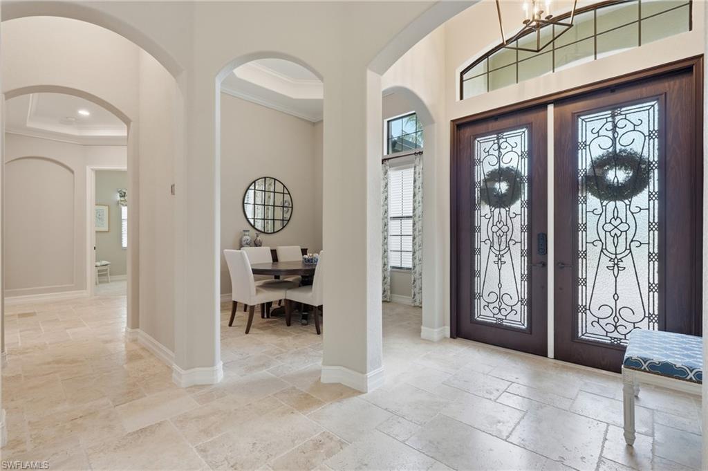 Image 3: Grand entryway featuring double doors with decorative glass panels and transom window