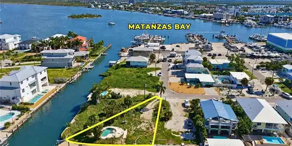 Image 2: Waterfront lot with canal access featuring a private dock and a small pool - Virtually Edited Image