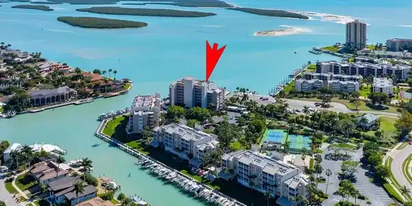 Image 2: Aerial overview of property's location with a large body of water