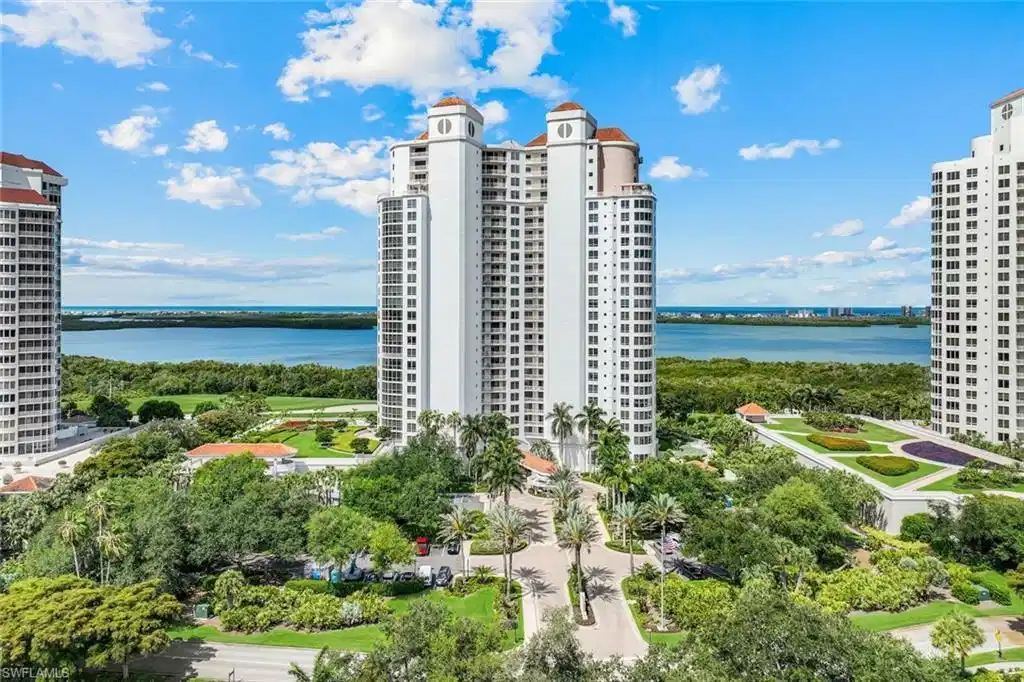 Image 1: Aerial view of the majestic Estancia high-rise in Bonita Bay, with Estero Bay and the Gulf of America in the background.