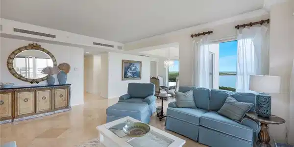 Image 3: The decor of the living room provides a relaxing coastal vibe.