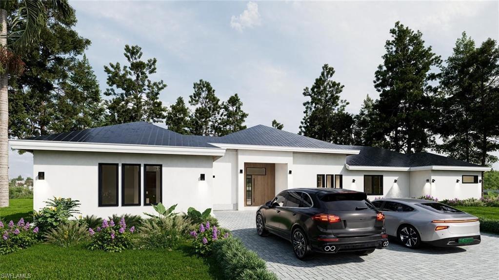Image 1: View of front of home with stucco siding, driveway, and a front lawn