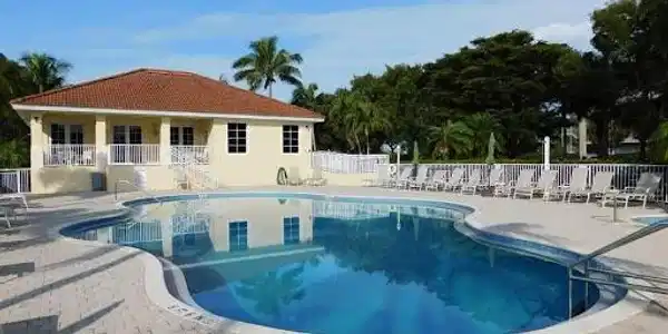 Image 3: Community pool with a patio