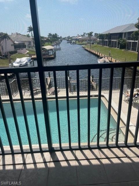 Image 2: Community pool with a balcony and a water view