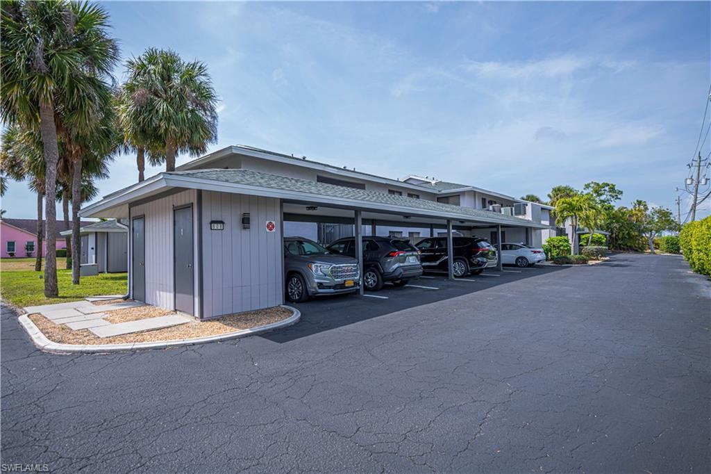 Image 4: View of building exterior with covered parking