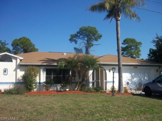 Image 1: Ranch-style home featuring an attached garage, a front yard, and stucco siding
