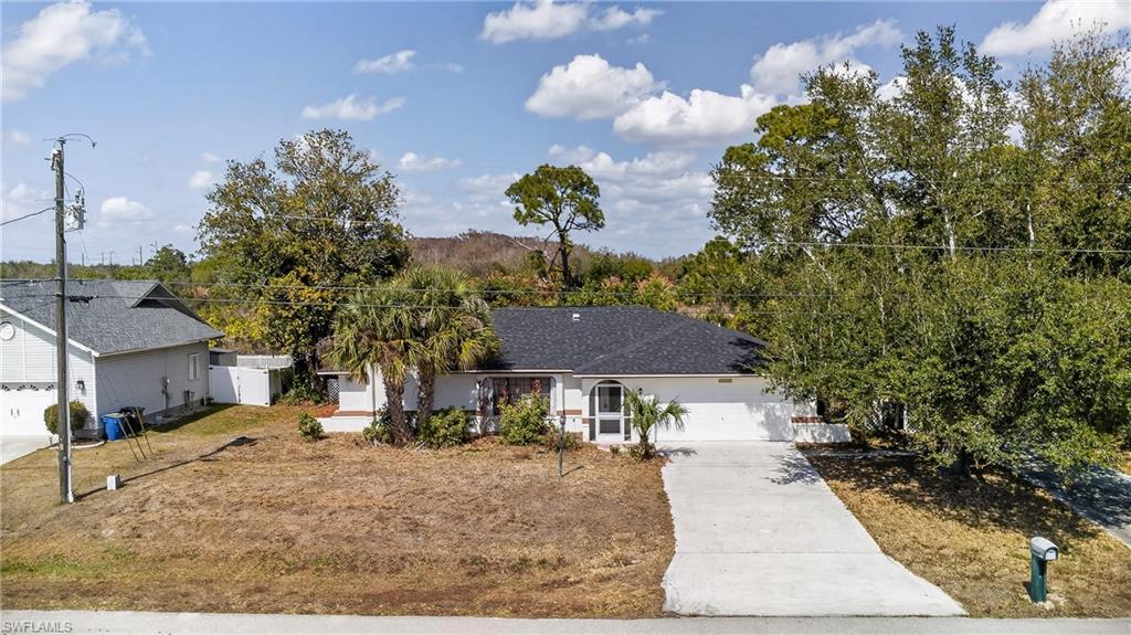 Image 2: Ranch-style home featuring concrete driveway and a garage