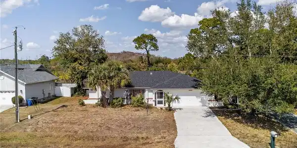 Image 2: Ranch-style home featuring concrete driveway and a garage