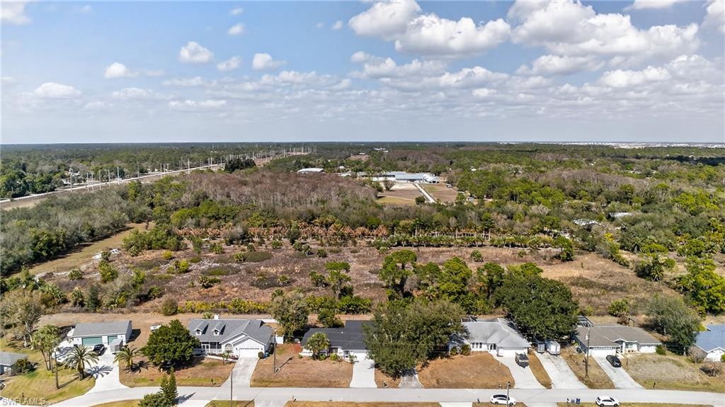 Image 4: Aerial perspective of suburban area featuring a forest